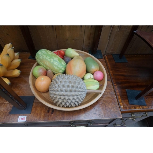 1161 - A collection of novelty painted and carved life-size fruit, together with a turned wood bowl, 38cm d... 