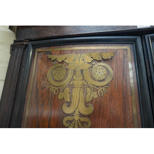 1172 - An oak standing corner cupboard, the upper part comprising a pair of 19th century rosewood and brass... 