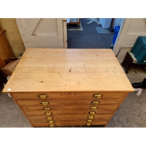 1182 - An antique pine seven drawer plan chest, 106.5cm wide.