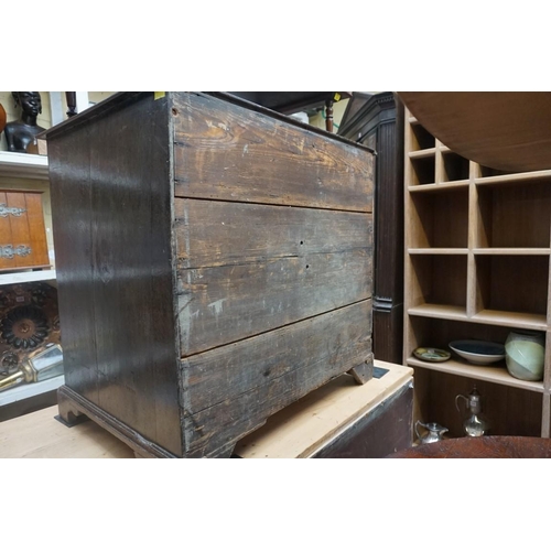 1183 - A small antique oak chest of four long graduated drawers, 68.5cm high x 73.5cm wide x 50cm deep... 