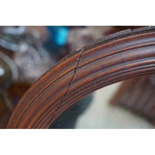 1190 - A Victorian turned mahogany adjustable shaving mirror, 35.5cm diameter. 