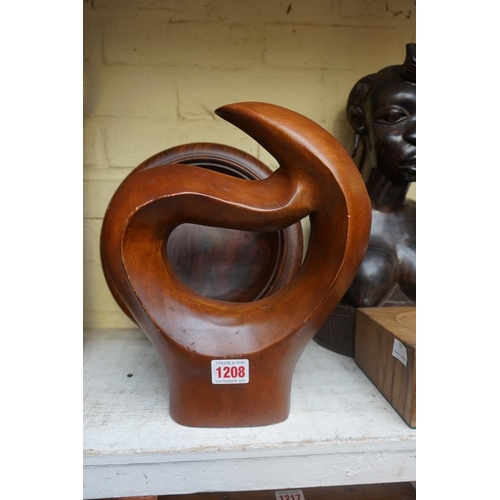 1208 - Manner of Barbara Hepworth, a carved teak sculpture, 28cm high, on associated oak stand; together wi... 