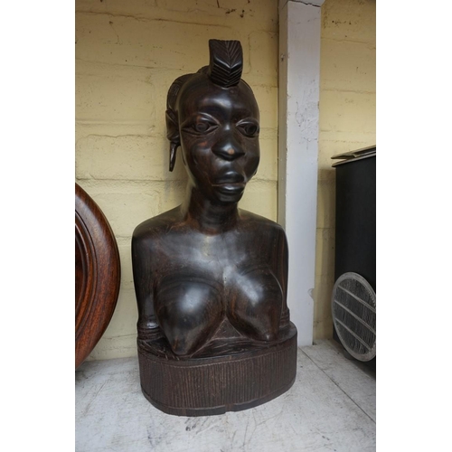 1208 - Manner of Barbara Hepworth, a carved teak sculpture, 28cm high, on associated oak stand; together wi... 