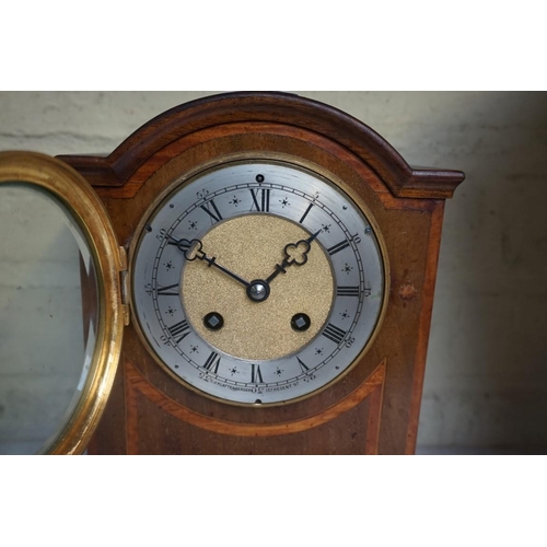 1214 - An early 20th century mahogany and satinwood banded mantel clock, the silvered chapter ring inscribe... 