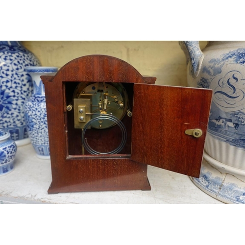 1214 - An early 20th century mahogany and satinwood banded mantel clock, the silvered chapter ring inscribe... 