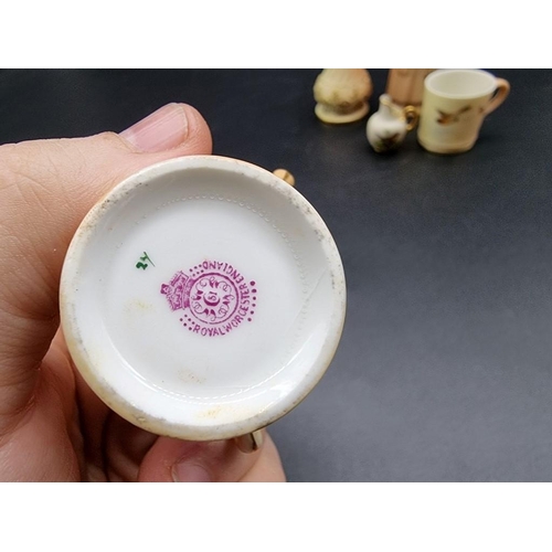 1251 - A small group of Royal Worcester miniature blush ivory items, comprising: a coffee can, painted with... 