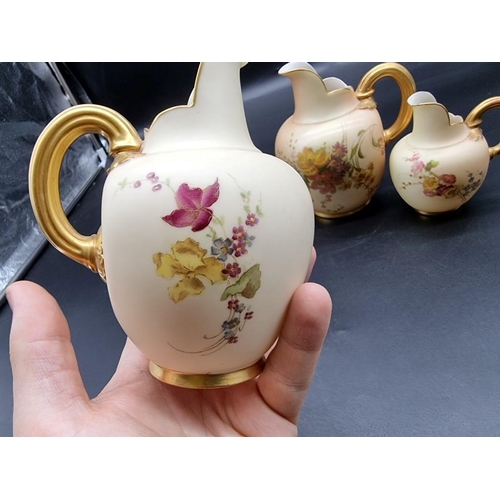 1253 - A graduated set of three royal Worcester blush ivory ewers, shape no. 1094, largest 15.5cm high. (3)... 