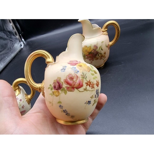 1253 - A graduated set of three royal Worcester blush ivory ewers, shape no. 1094, largest 15.5cm high. (3)... 