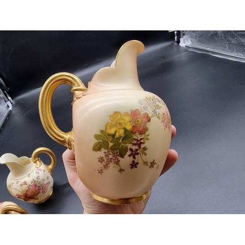 1253 - A graduated set of three royal Worcester blush ivory ewers, shape no. 1094, largest 15.5cm high. (3)... 