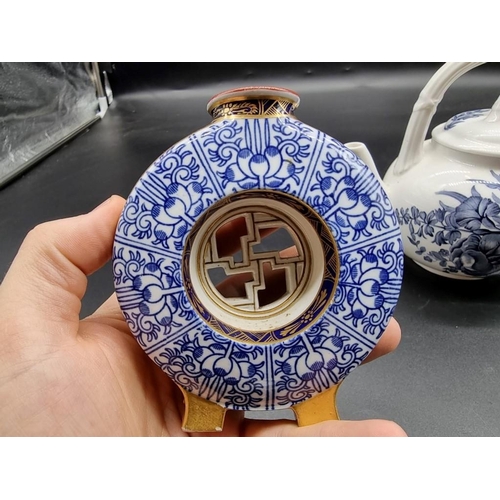 1261 - A Royal Worcester moon flask, in the Oriental style, with pierced centre, 10.5cm high; together with... 