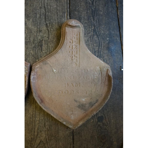 1388 - A set of three Reed Patent terracotta roof tiles, inscribed 'Ham, Dorset', of spade form, 41 x 30cm.... 