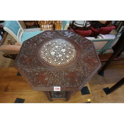 1395 - A Moorish carved hardwood and bone inlaid octagonal folding table, 58cm diameter.