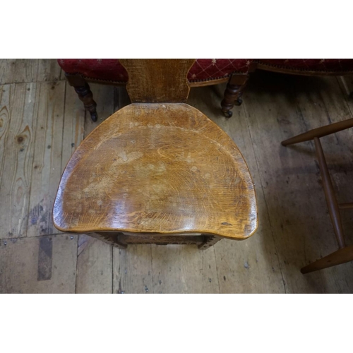 1404 - An early 20th century carved oak spinning stool, with saddle seat. 