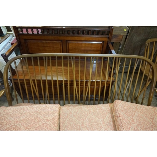 1414 - An Ercol three seater Windsor settee, 173cm wide.