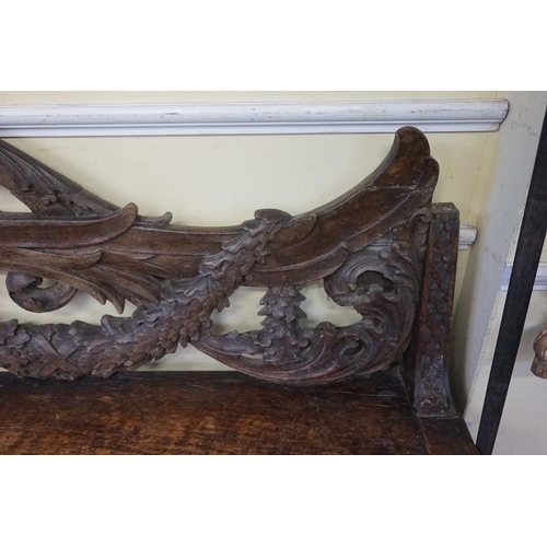 1429 - A large and unusual 19th century Continental carved walnut hall bench, probably Italian, 236.5cm wid... 