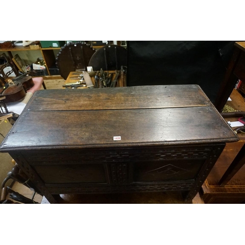 1439 - A late 17th century carved oak panelled coffer, 103cm wide, (repair to one front panel). ... 