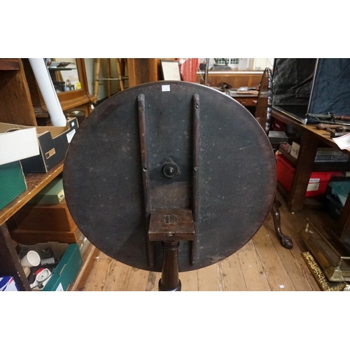 1444 - A George III mahogany circular tilt top tripod table, with one piece top, 74cm diameter, (repairs to... 