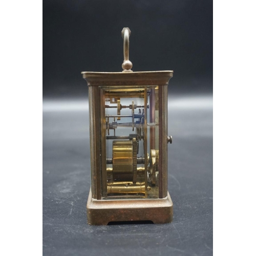 1462 - An old brass carriage timepiece, height including handle 14cm, with winding key. ... 