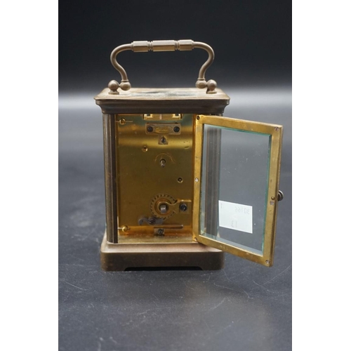 1462 - An old brass carriage timepiece, height including handle 14cm, with winding key. ... 