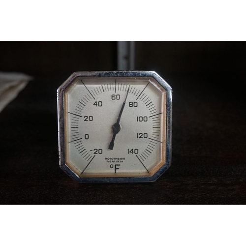 1466 - An Art Deco chrome desk timepiece, 14cm wide; together with a similar desk calendar; and thermometer... 