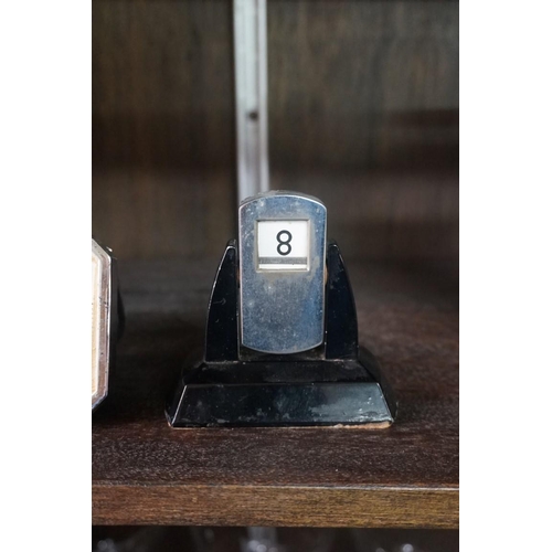 1466 - An Art Deco chrome desk timepiece, 14cm wide; together with a similar desk calendar; and thermometer... 