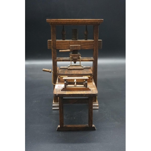 1489 - A beechwood novelty model of a printing press, 26cm high x 23cm wide.