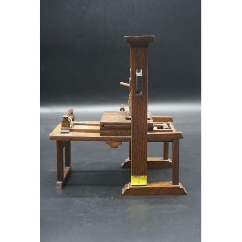 1489 - A beechwood novelty model of a printing press, 26cm high x 23cm wide.