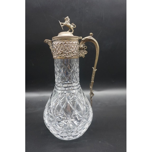 1521 - A plated metal mounted cut glass claret jug; together with another plated metal example, latter 33cm... 