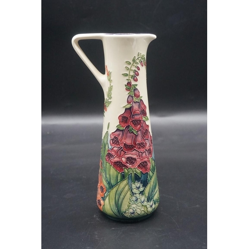 1522 - A Moorcroft 'Foxglove' pattern jug, signed by Rachel Bishop, 24cm high, a boxed.