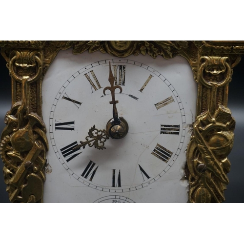 1557 - An antique French cast brass mantel clock, with enamel dial, 24cm high.