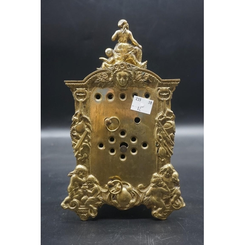 1557 - An antique French cast brass mantel clock, with enamel dial, 24cm high.