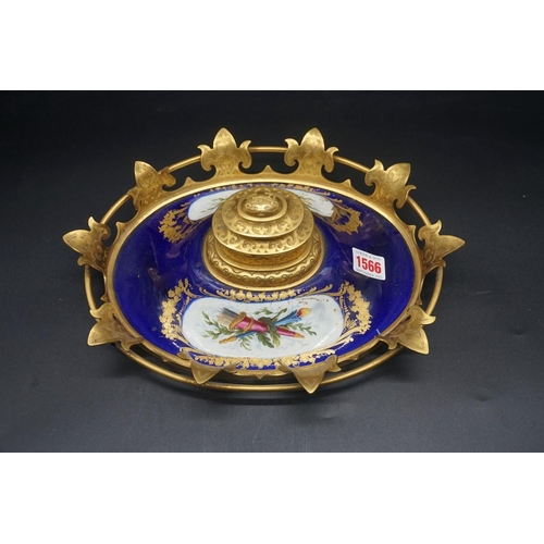 1566 - An elaborate 19th century porcelain and gilt brass mounted inkwell, 30cm wide; together with a simil... 