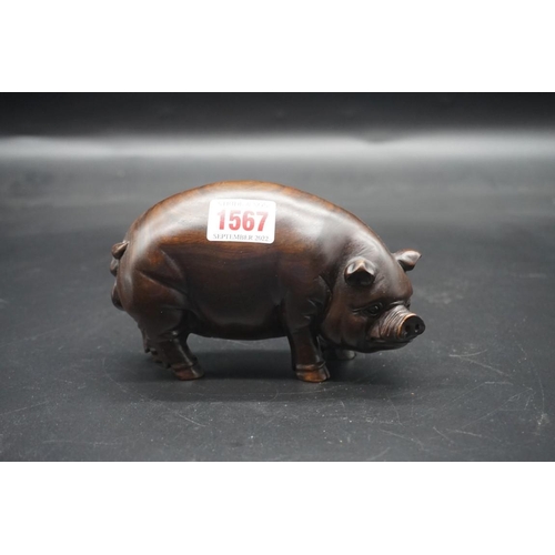 1567 - A pair of Chinese or Japanese carved hardwood pigs, each signed, approx 15cm long.