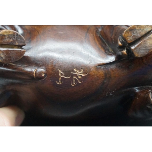 1567 - A pair of Chinese or Japanese carved hardwood pigs, each signed, approx 15cm long.