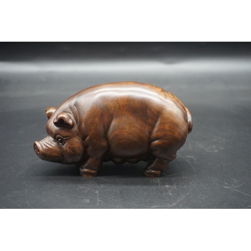 1567 - A pair of Chinese or Japanese carved hardwood pigs, each signed, approx 15cm long.