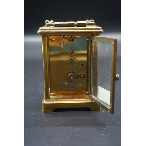 1576 - An antique brass carriage timepiece, height including handle 14.5cm, in original leather travel case... 