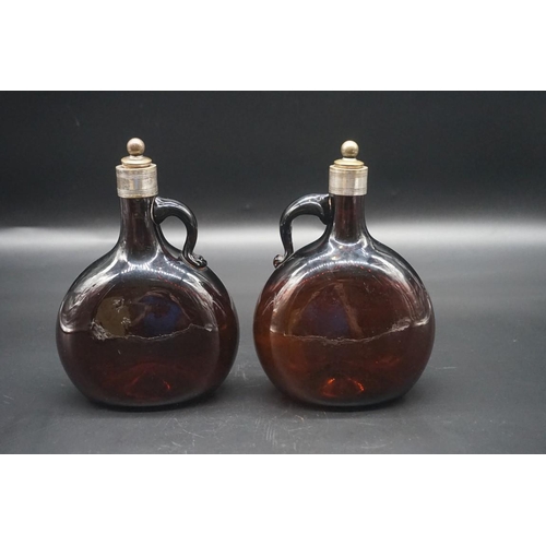 1585 - A pair of dark amber glass decanters and stoppers, 19cm high. 