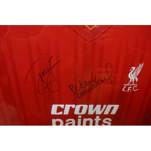 1610A - Liverpool FC: a signed shirt, by John Barnes, Ian Rush and Peter Beardsley, framed and glazed.... 