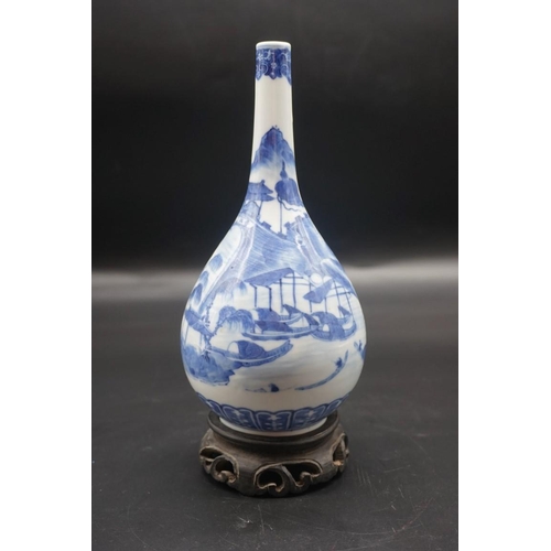 1634 - A Chinese blue and white bottle vase, Kangxi four character mark to base, 20cm high, on hardwood sta... 