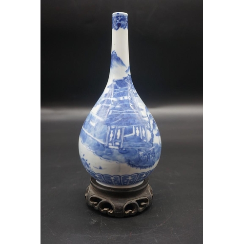 1634 - A Chinese blue and white bottle vase, Kangxi four character mark to base, 20cm high, on hardwood sta... 