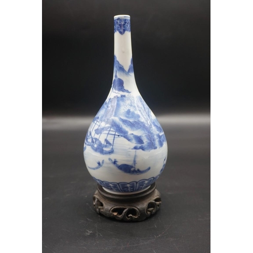 1634 - A Chinese blue and white bottle vase, Kangxi four character mark to base, 20cm high, on hardwood sta... 