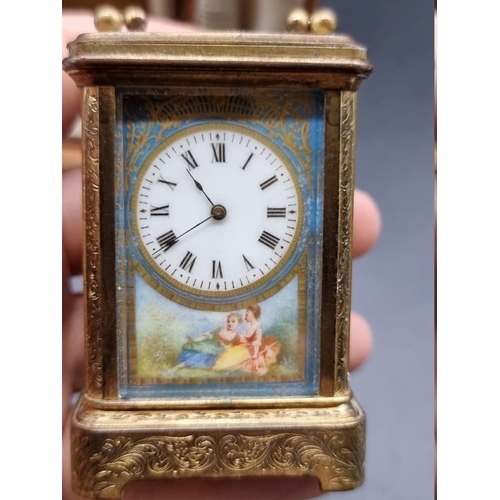 1652 - A good miniature late 19th century engraved gilt brass and porcelain carriage timepiece, the panels ... 