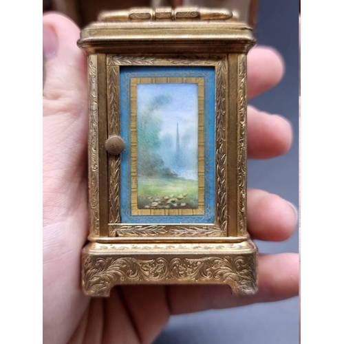 1652 - A good miniature late 19th century engraved gilt brass and porcelain carriage timepiece, the panels ... 