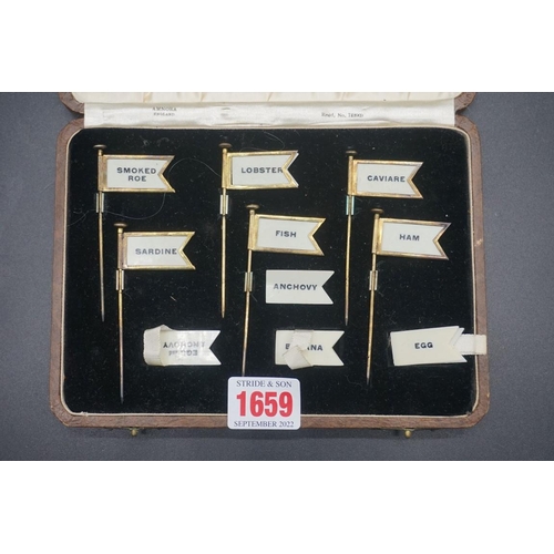 1659 - A set of brass ivorine buffet food flags, in associated case.