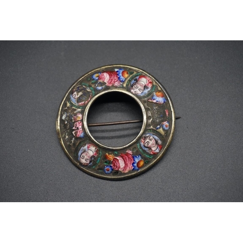 1673 - A 19th century Qajar enamel circular brooch, painted with four oval portraits separated by floral mo... 