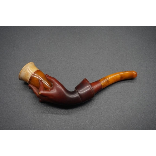 1678 - A small antique carved amber and meerschaum pipe, 10.5cm long, (repair to little finger), in le... 