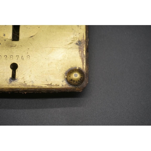 1680 - A Louis Vuitton gilt brass lower lock base plate, No.028748, 10 x 7cm.