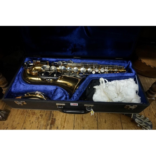 1703 - A brass saxophone, in padded case.