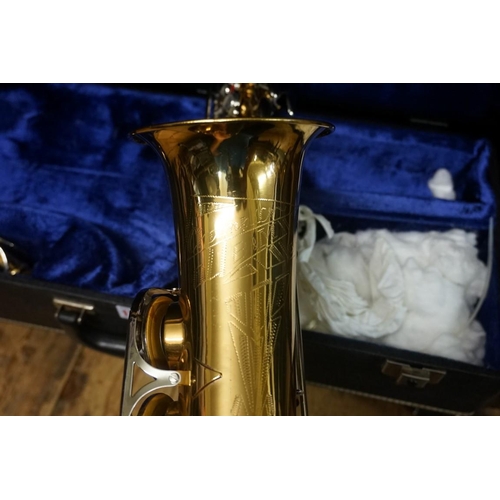 1703 - A brass saxophone, in padded case.