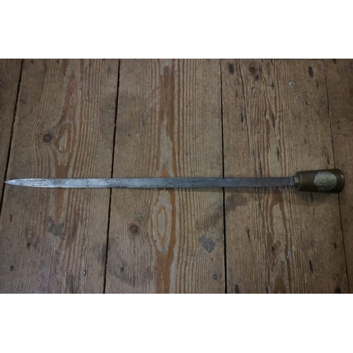 1718 - An antique swordstick, the brass handle with regimental crest.